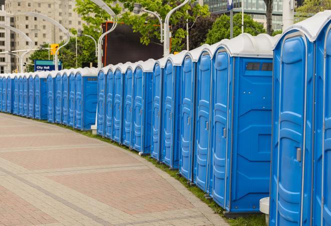 a row of portable restrooms set up for a large athletic event, allowing participants and spectators to easily take care of their needs in North Providence